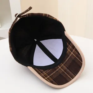 Detail of checkered autumn kids baseball cap showing internal lining and adjustable strap