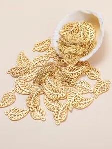 Detailed view of hollow gold leaf pendants featuring intricate filigree design for DIY jewelry