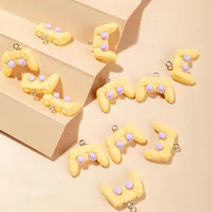 Creative yellow and purple resin game controller charms for DIY keychains and accessories