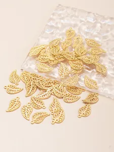 Detailed view of golden hollow leaf pendants with intricate veins and connector rings