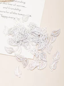 Detailed macro view of antique silver hollow leaf charms with intricate vein textures
