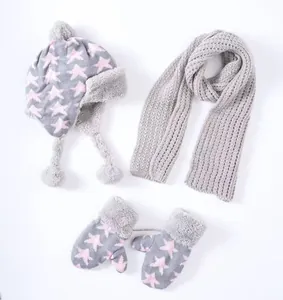 Détail de l'ensemble hiver enfant avec bonnet à pompon, écharpe et gants étoilés gris