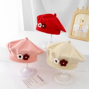 Three-piece baby knit beret set in red, pink, and beige with 3D floral accents
