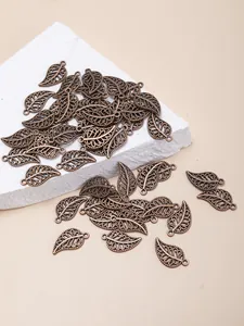 Detailed macro view of antique bronze alloy hollow leaf pendants for DIY jewelry making