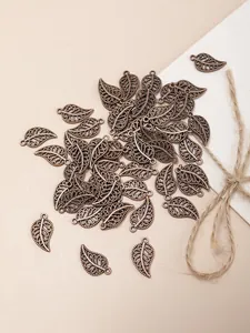 Macro shot of antique bronze filigree leaf pendants for DIY jewelry making and crafts