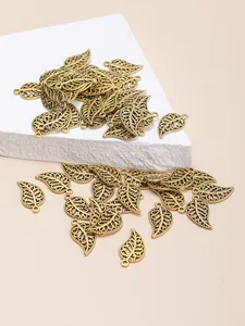 Detail of antique gold leaf pendants with hollow veins for DIY jewelry making