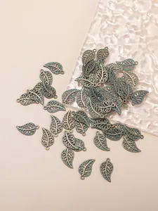 Macro shot of antique bronze alloy leaf charms with hollow veins for DIY jewelry making