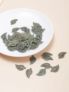 Detail of vintage bronze hollow leaf charms for DIY jewelry making and earrings