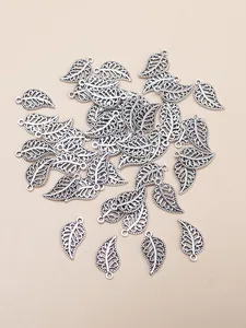 Macro view of vintage silver alloy hollow leaf pendants with detailed vein texture