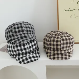 Detailed macro view of winter woolen newsboy caps in three classic plaid patterns for kids