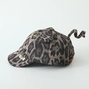Kids leopard print baseball cap with cute ears and tail detail on a white background