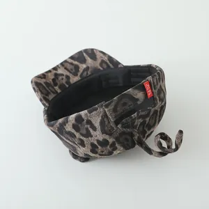 Detail of leopard print baby baseball cap featuring a cute tail and Di Di Cute label