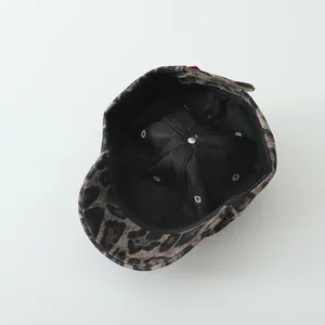 Detail view of leopard print hat showing black lining and adjustable metal buckle