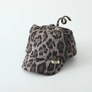 Detailed close-up of leopard print toddler baseball cap with cute tail and ear accents