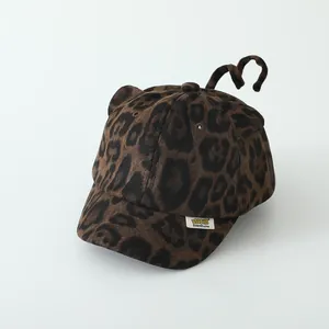 Detail of leopard print baby baseball cap featuring 3D ears and cute long tail decoration