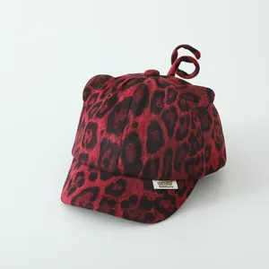 Detailed view of red leopard print baby baseball cap with plush cat ears and cute tail decor