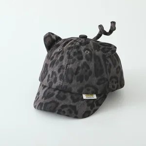 Close-up of leopard print toddler baseball cap with cute ears, tail, and fabric label