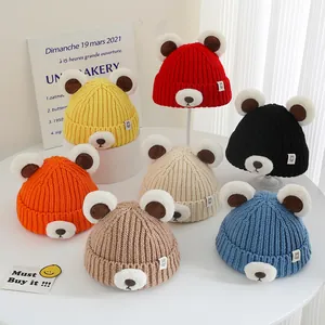 Detailed view of children's knit beanies with bear ears in seven assorted colors