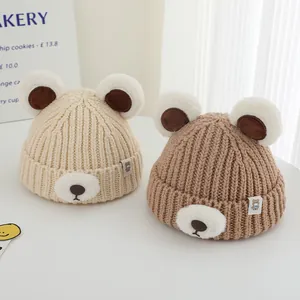 Detailed close-up of cute bear-shaped winter beanies with plush ears and soft knit fabric