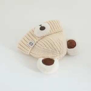 Beige knit baby hat with 3D bear ears and soft crochet texture for toddlers
