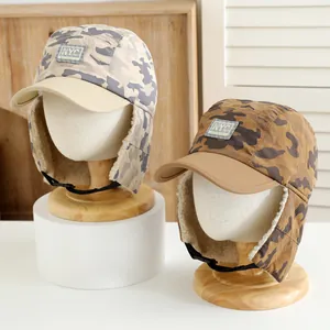 Detail of kids winter camo trapper hat with warm fleece lining and NYC embroidery
