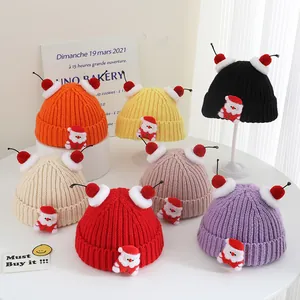 Collection of warm winter knitted hats with pom-poms and cute Santa Claus patches