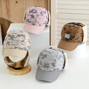 Close-up of kids camouflage winter trapper hats with NYC patch and warm fleece lining
