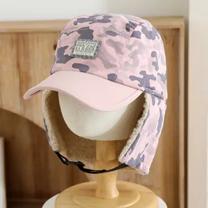 Detailed view of pink camo winter trapper hat with fleece lining and NYC patch