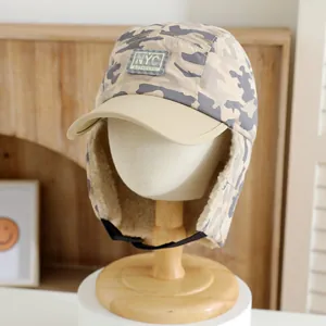 Detailed close-up of winter camo trapper hat with fleece lining and NYC patch