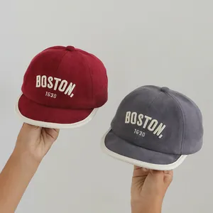 Infant soft brim baseball caps in burgundy and grey with BOSTON embroidery text
