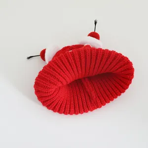 Detail of red knit kids hat with cute cartoon antennae and soft white plush decor
