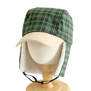 Kids winter trapper hat with green plaid pattern and warm fleece earflaps for wind protection
