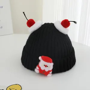 Winter kids black knit hat with red pom-poms and cute Santa Claus patch for ages 2-7