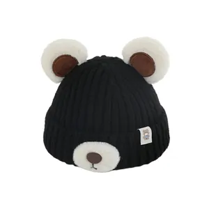 Cute black baby knit hat with white plush bear ears and snout for winter warmth