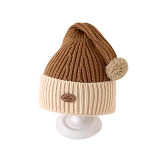 Toddler winter knit beanie with caramel and cream color blocking and plush pom-pom