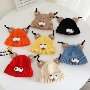 Overhead view of colorful knitted monster hats for kids with tentacles and large eyes