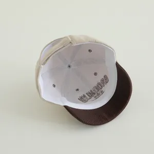 Close-up of internal corduroy texture and adjustable back strap of the baby baseball cap