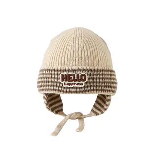 Winter knit baby hat with ear flaps, cream stripes and HELLO happiness patch
