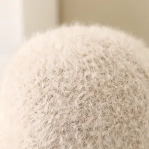 Close-up of the ultra-soft beige faux fur pom-pom detail on a kids winter fisherman hat