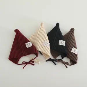 Detailed texture of baby pointed knitted hats in four colors with adjustable chin straps