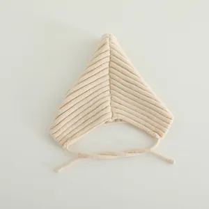 Detailed view of beige knit baby elf hat with pointed top and soft ribbed texture