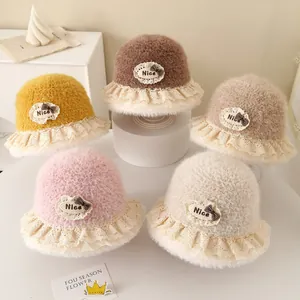 Detailed view of plush warm bucket hats in five soft colors with lace trim and bow accent