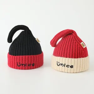 Close-up of knit texture and embroidered NICE letters on children's beanie hats