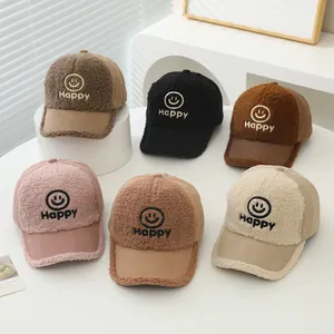 Close-up of kids corduroy baseball caps in six colors with happy face embroidery