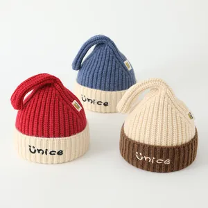 Thick knitted kids winter beanies with NICE letter embroidery and top loop detail