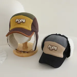 Close-up of winter earflap cap with warm fleece lining and PUPLL KIDS embroidery