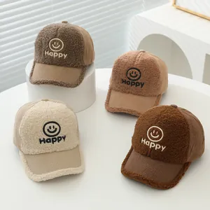 Detail showing plush corduroy textures and embroidered happy face on toddler baseball caps