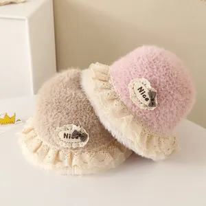 Winter plush baby bucket hats with lace trim and bow accents in pink and beige colors