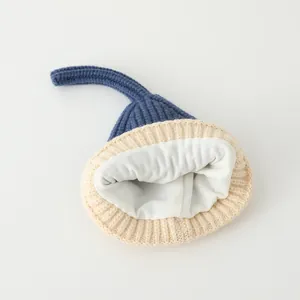 Detail view of thick knitted kids hat with cozy fleece lining and color block design