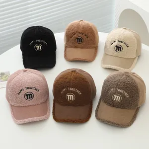 Detailed view of kids corduroy baseball caps with soft teddy fleece trim and M embroidery